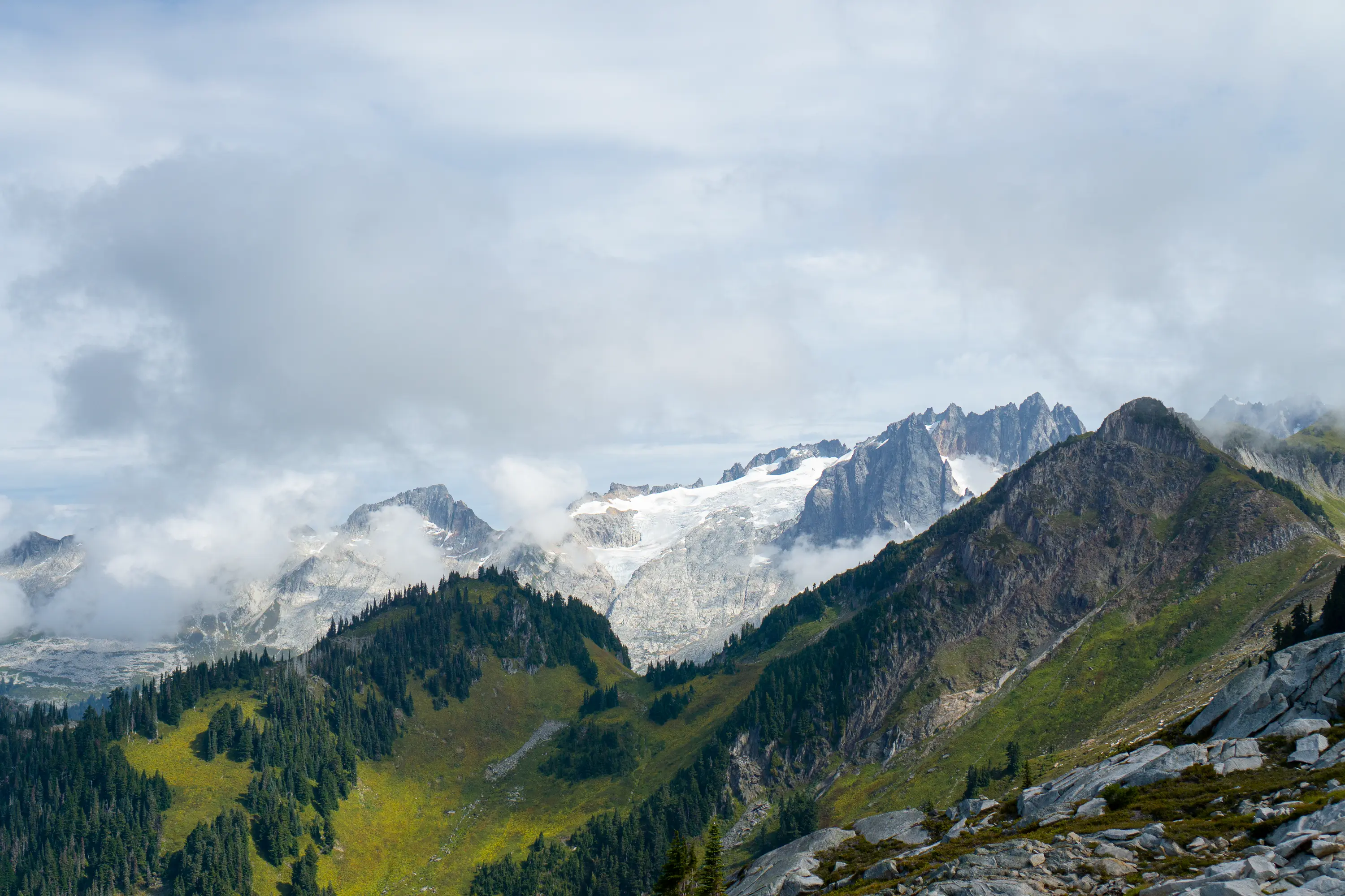 Dorrado Needle and Eldorado peak on the horizon, Marble Creek drainable in the foreground. Behind these peaks lies the Inspiration-McAllister-Klawatti icecap, the largest non-volcanic glaciated area in the lower 48 states. Hidden Lake Peaks, North Cascades