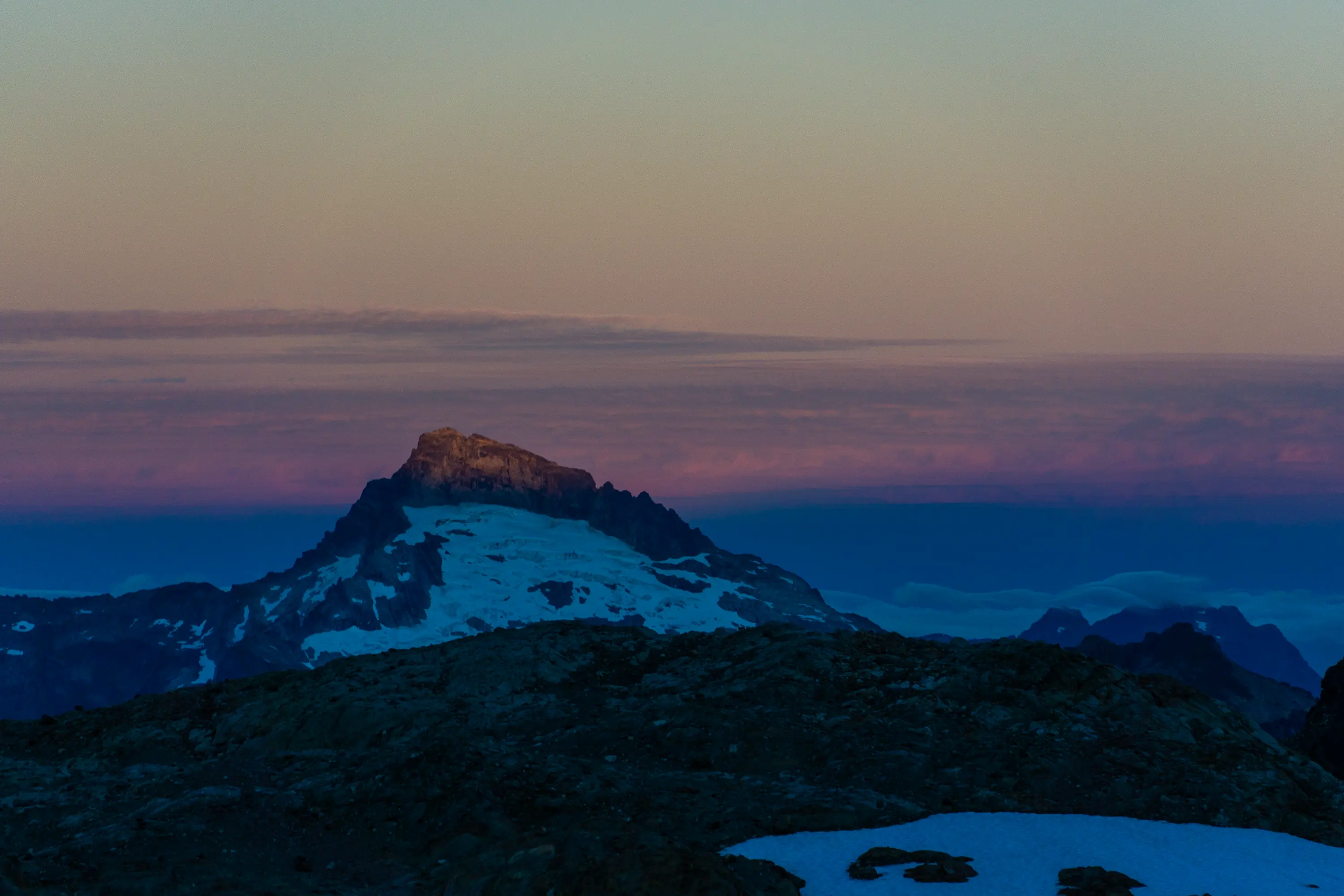 Sloan Peak sunrise, during ascent of Glacier Peak. Taken from the space formerly occupied by the Whitechuck Glacier.