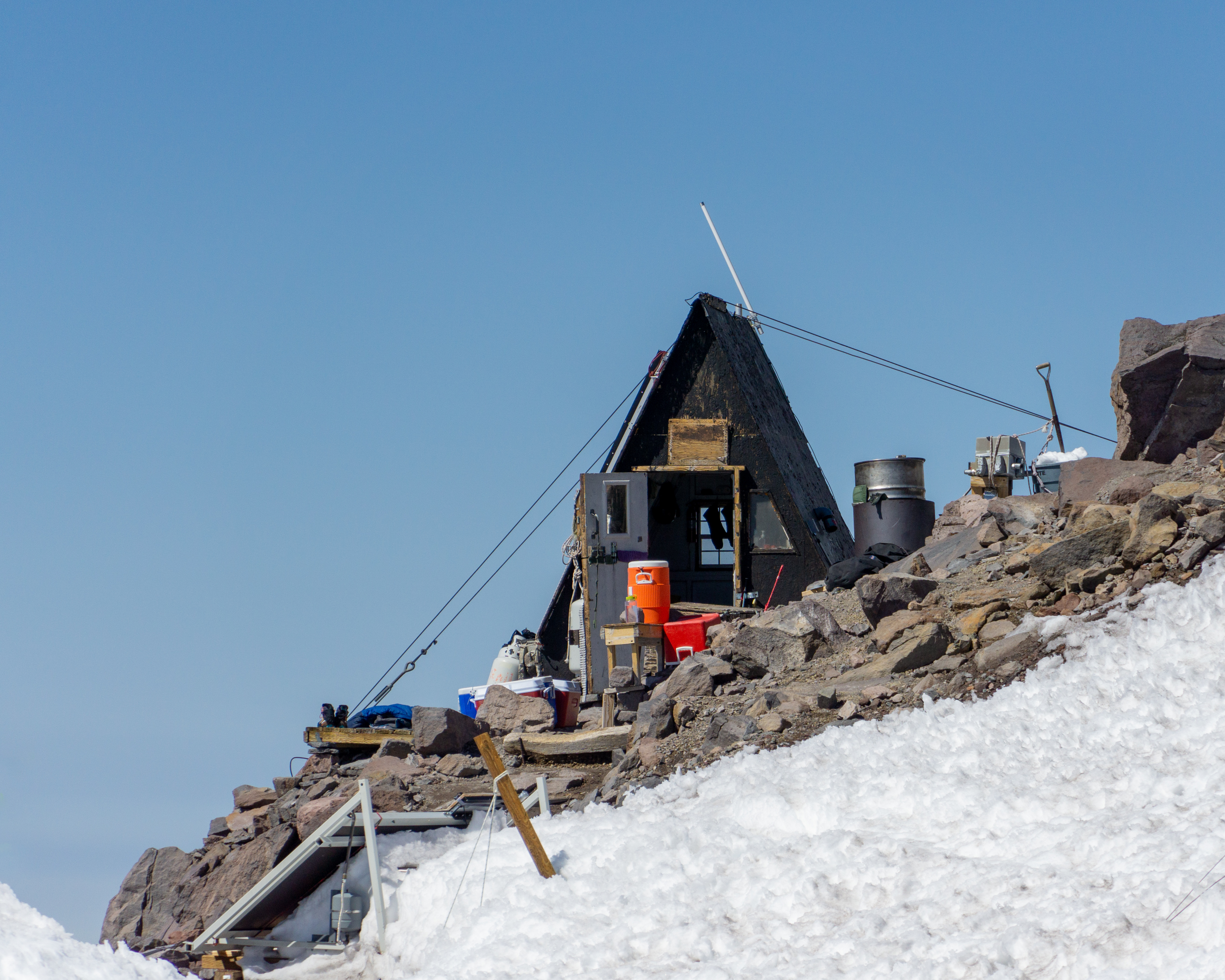 "Butler Shelter" a small A-Frame shelter used by guiding services at Camp Muir on Mt. Rainier. Highest permanent structure in Washington State. Here, on a warm day, gear expands to fill the space it's given.