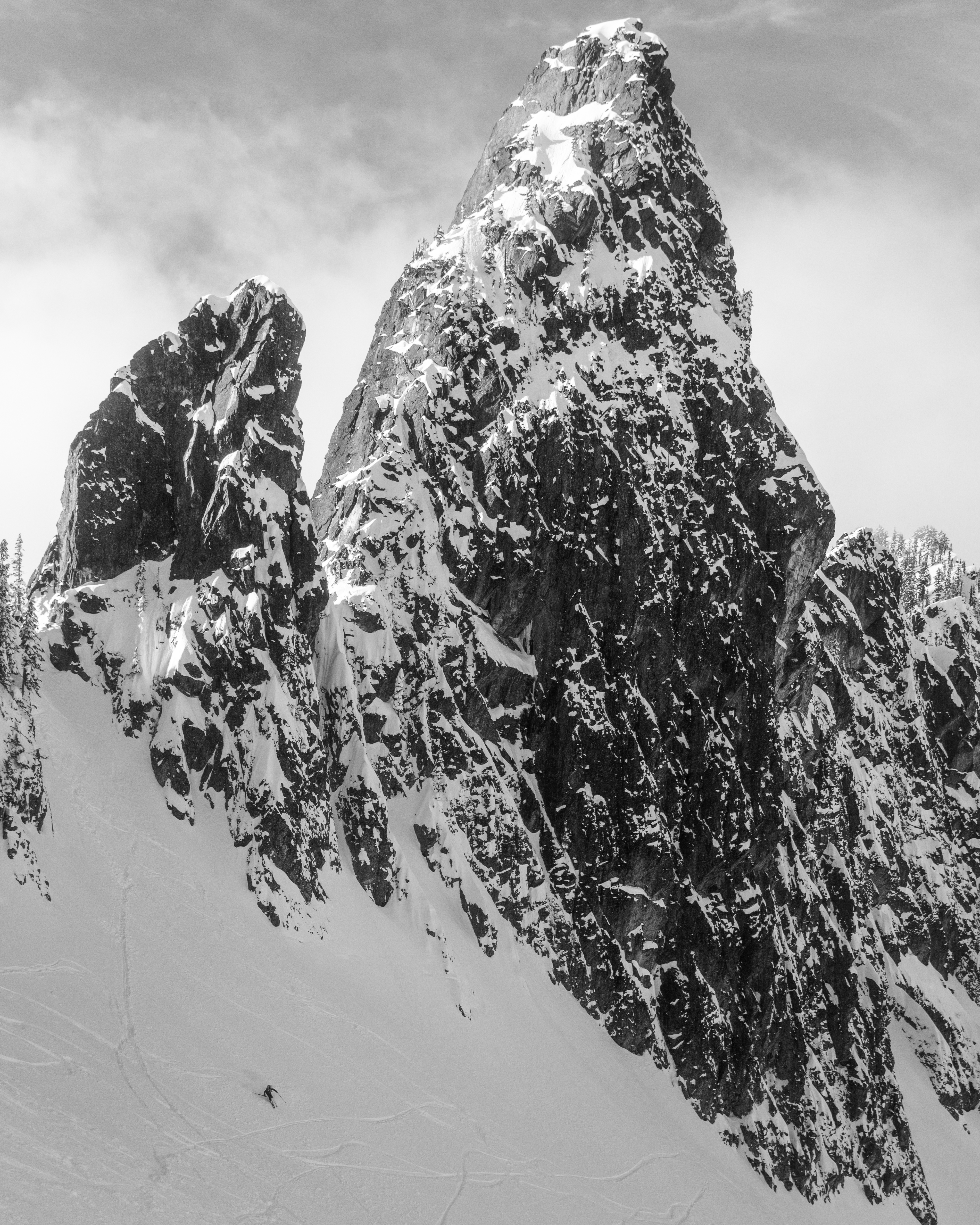 A friend looking like a total badass skiing Pineapple Pass. The Tooth in the background.